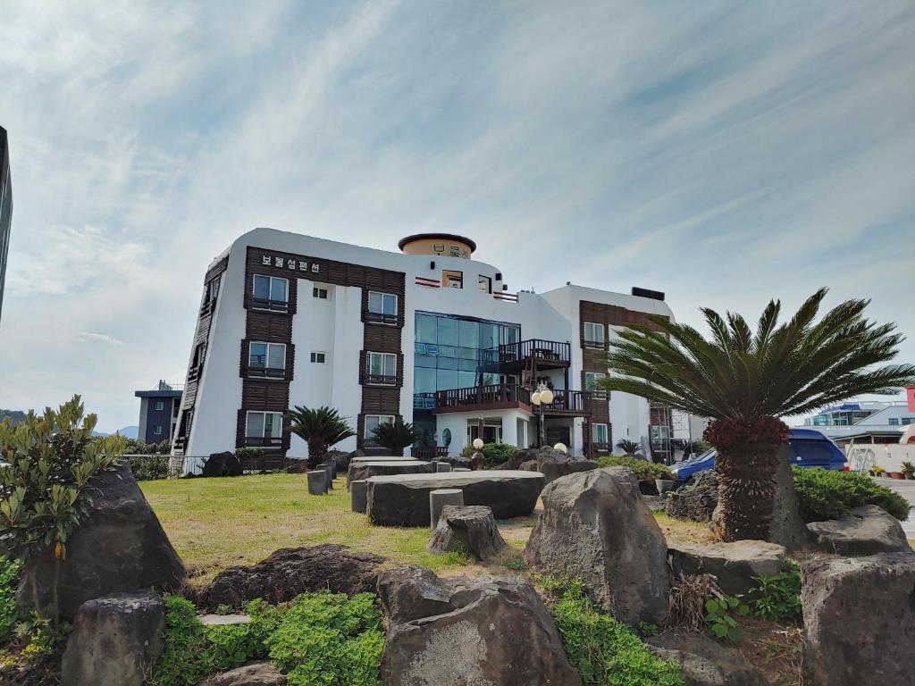 a building with rocks in front of it at Bomulsum in Seogwipo