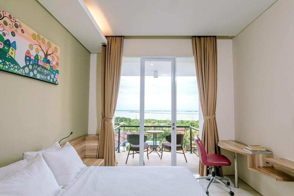 Postel nebo postele na pokoji v ubytování Mahogany Hotel