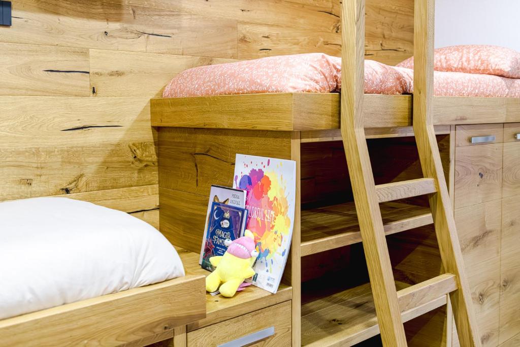 a bedroom with two bunk beds and a picture and a stuffed animal at Appartamento San Carlo in Tirano