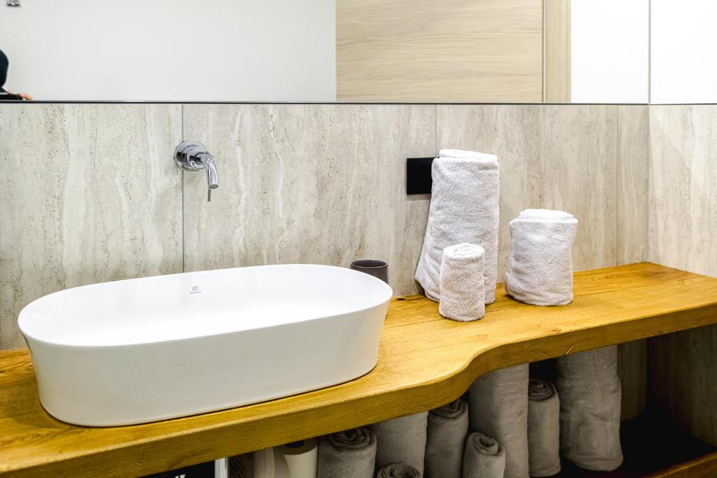 a bathroom with a white sink on a wooden counter at Appartamento San Carlo in Tirano