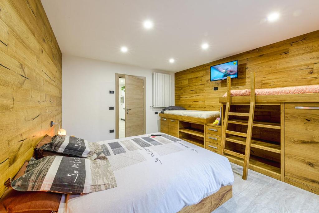 a bedroom with a bed and a tv on a wall at Appartamento San Carlo in Tirano