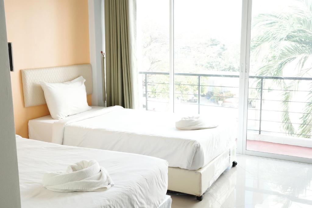 Postel nebo postele na pokoji v ubytování บ้านสวนรีสอร์ท นครสวรรค์