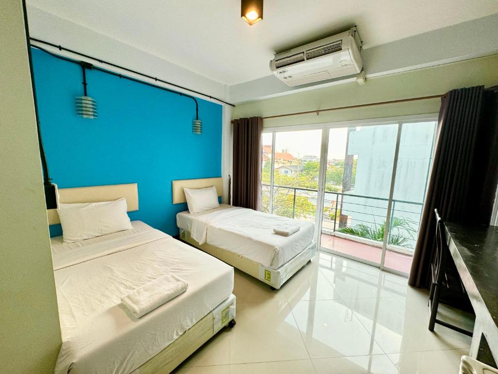 Postel nebo postele na pokoji v ubytování บ้านสวนรีสอร์ท นครสวรรค์