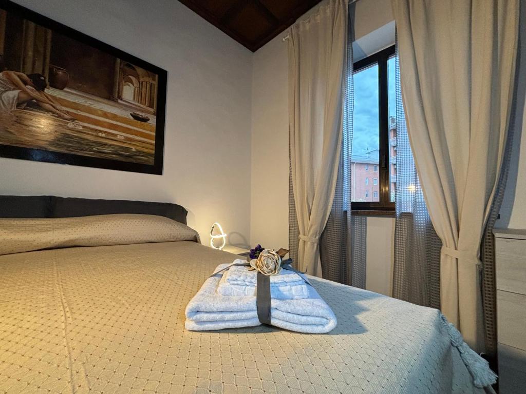 a bedroom with a bed with a towel on it at Villanova d'Asti Charming House with barbecue by Alterego in Villanova dʼAsti