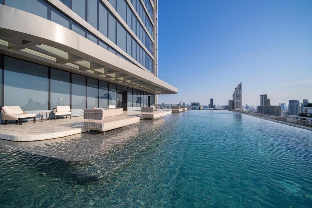 a swimming pool on the side of a building at Cozy 1-BR Luxury Getaway in the Heart of Bangkok in Bangkok