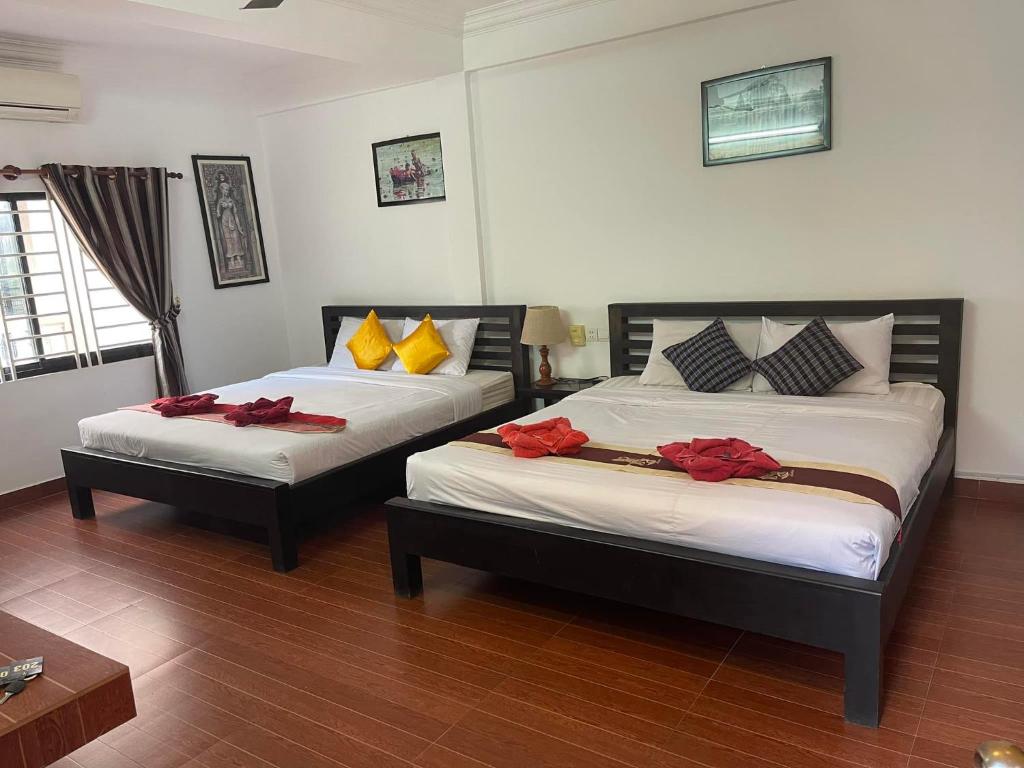 Ένα ή περισσότερα κρεβάτια σε δωμάτιο στο Victory Guest House