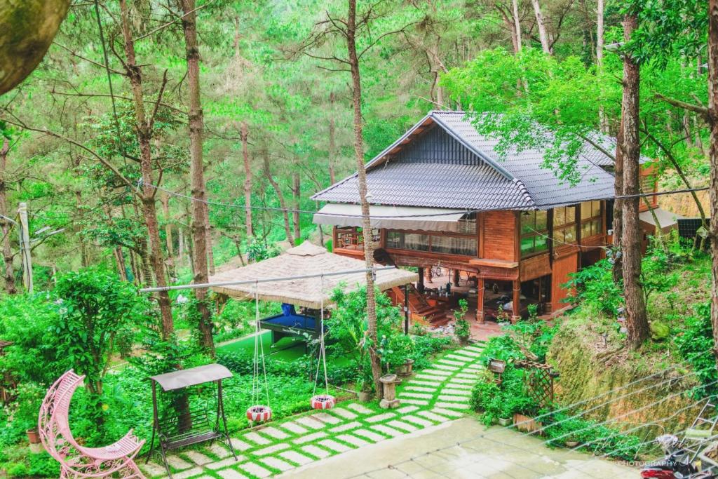 an aerial view of a house in the forest at Chou An Hideaway in Hanoi