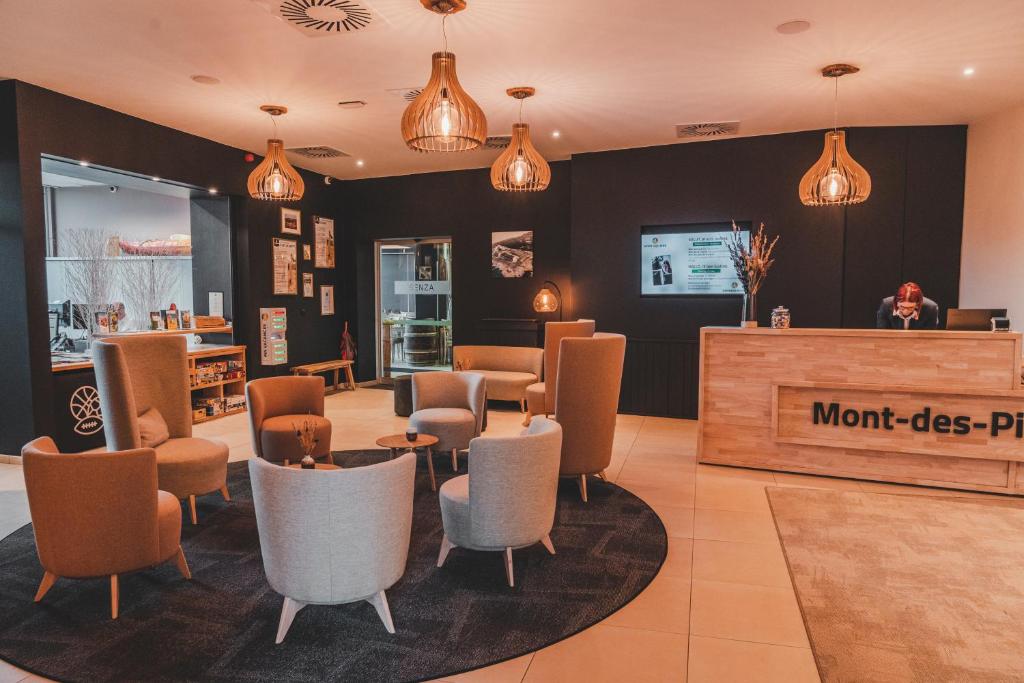 a restaurant with a waiting area with chairs and a counter at Mont-Des-Pins Domaine de Vacances, Vakantiedomein Dennenheuvel in Durbuy