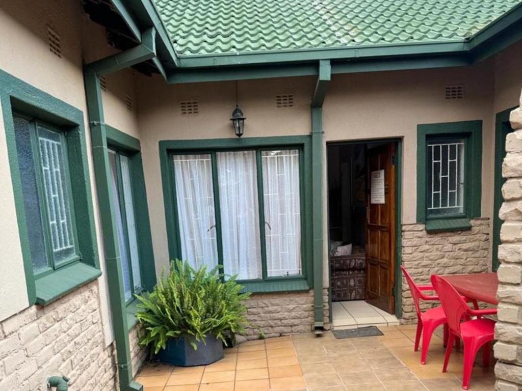 a house with a patio with a table and chairs at Dula Monate Holiday Flats in Bela-Bela