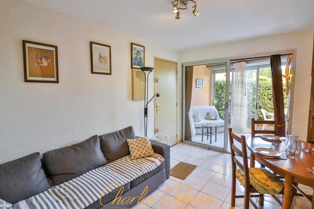 een woonkamer met een bank en een tafel bij Le "Pépère" charming apartment 150m from the beach in Sète