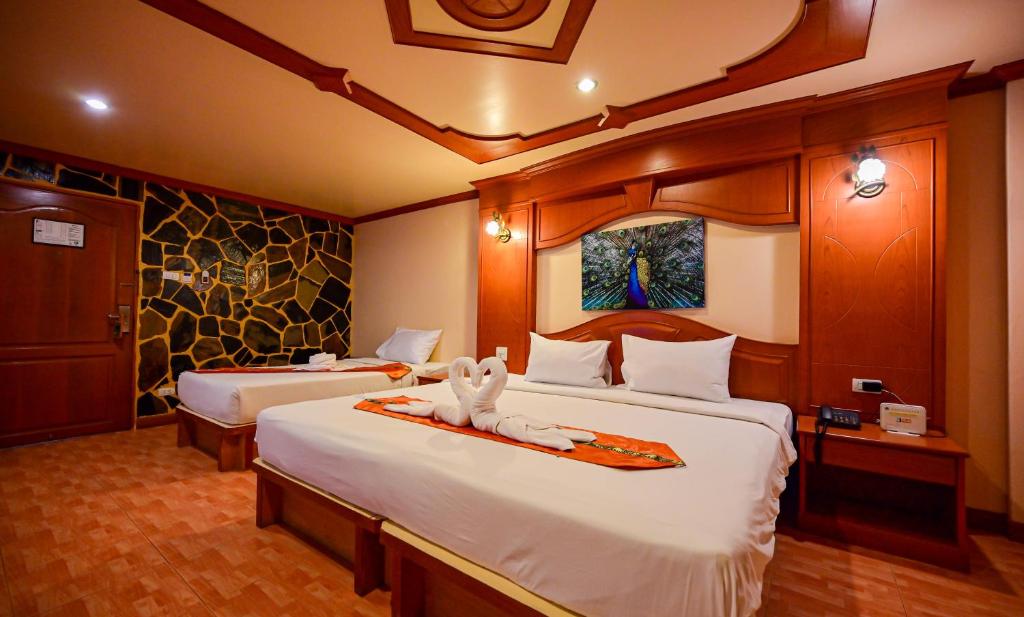 En eller flere senge i et værelse på Tiger Complex Patong