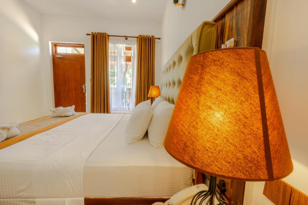 Postel nebo postele na pokoji v ubytování Elysia Sigiriya Hotel