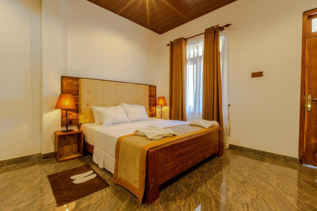 Postel nebo postele na pokoji v ubytování Elysia Sigiriya Hotel