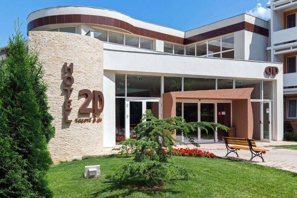 a building with a sign in front of it at Hotel 2D Resort and Spa in Neptun