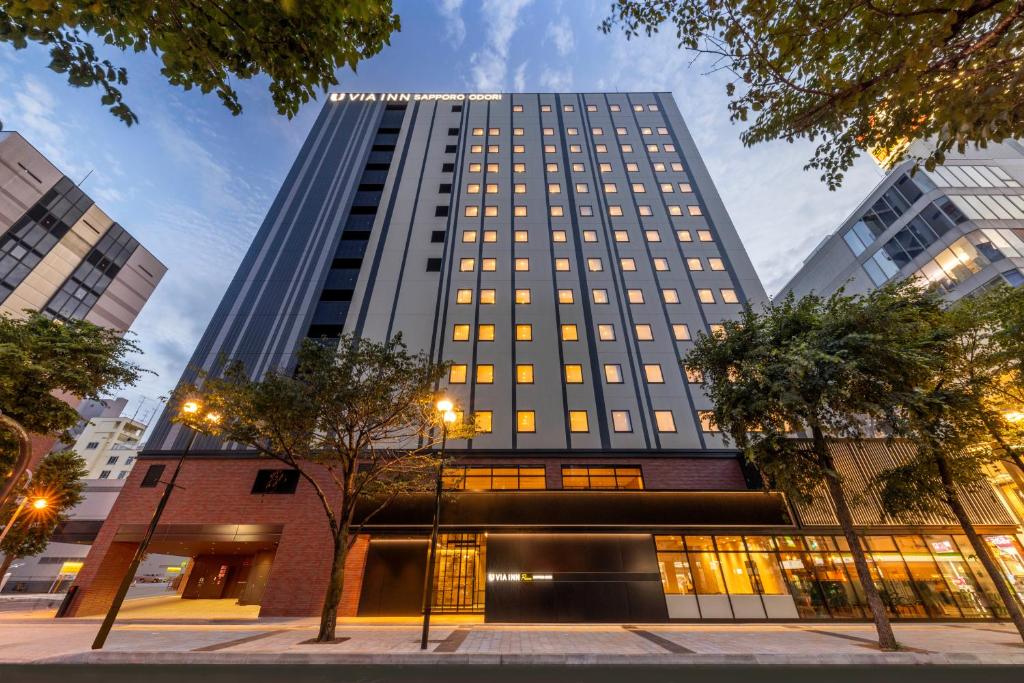 a tall building with windows in a city at Via Inn Prime Sapporo Odori in Sapporo