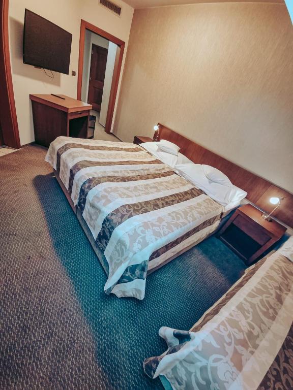 Postel nebo postele na pokoji v ubytování Hotel Mario