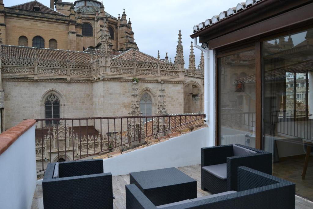 a balcony with a chair and a building at tuGuest Palacio de la Madraza in Granada
