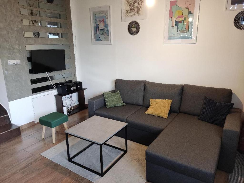 a living room with a couch and a tv at Gasperius apartments in Zagreb