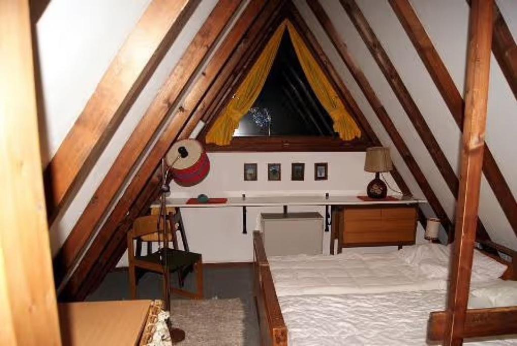 a attic room with a desk and a window at Ferienhaus Bergwiese in Siegsdorf