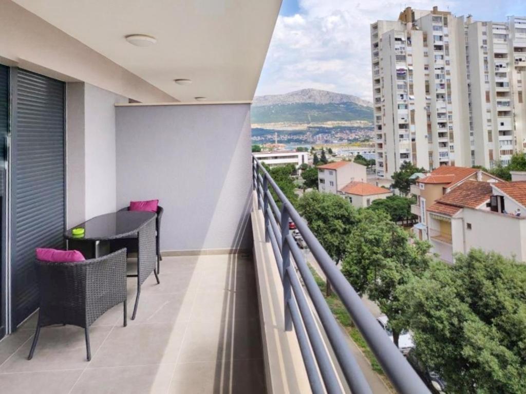 a balcony with a table and a view of a city at S`akvarel 7 - new & modern studio in Split