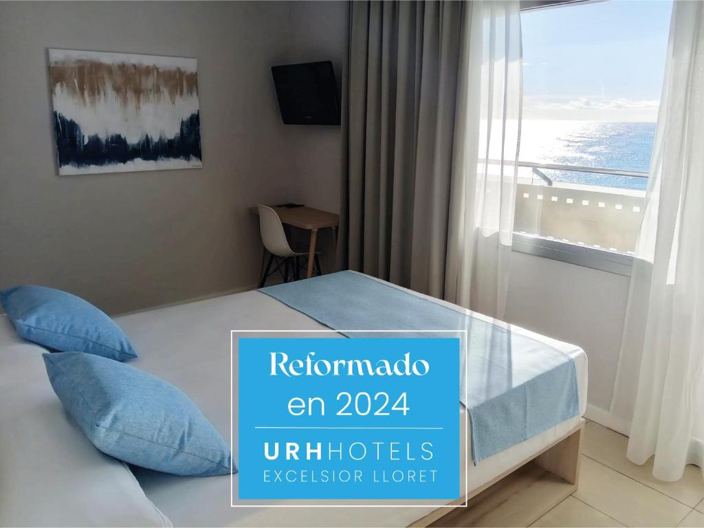 a hotel room with a bed with a window at URH Excelsior in Lloret de Mar