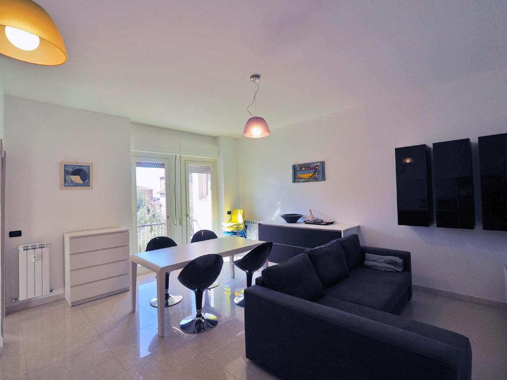 uma sala de estar com um sofá e uma mesa em GaBeDì Apartment em Lerici