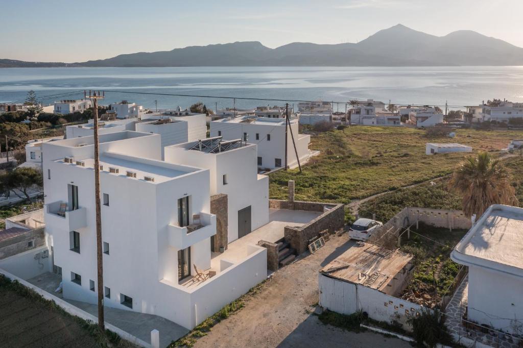 an aerial view of a white building with the ocean at Afroessa Milos in Adamantas