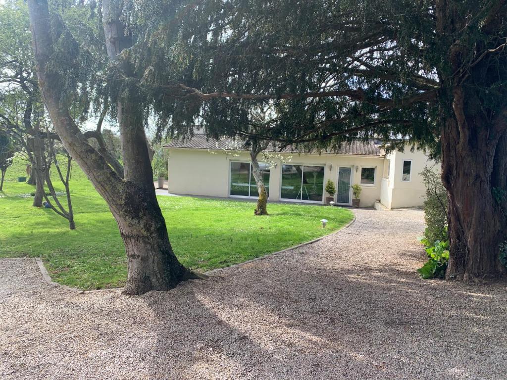 a house with a tree in front of it at Sur les Routes du Débarquement - Chambre Quadruple - in Bavent