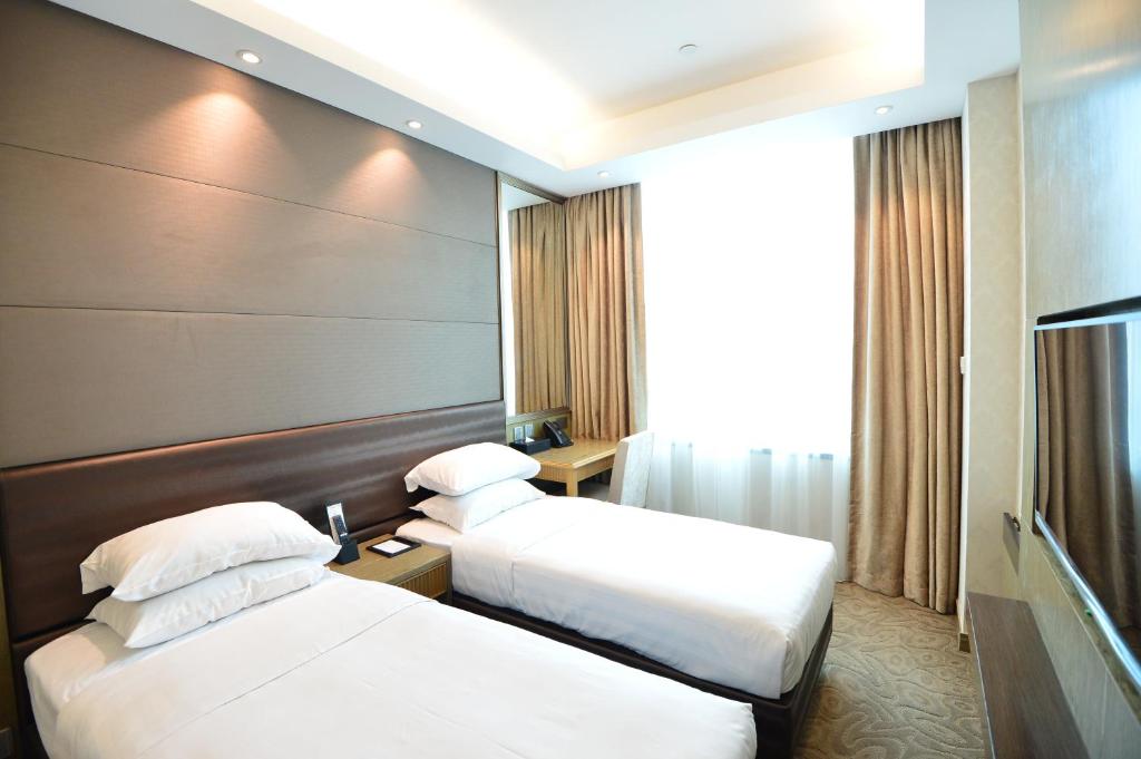Posteľ alebo postele v izbe v ubytovaní Kew Green Hotel Mongkok