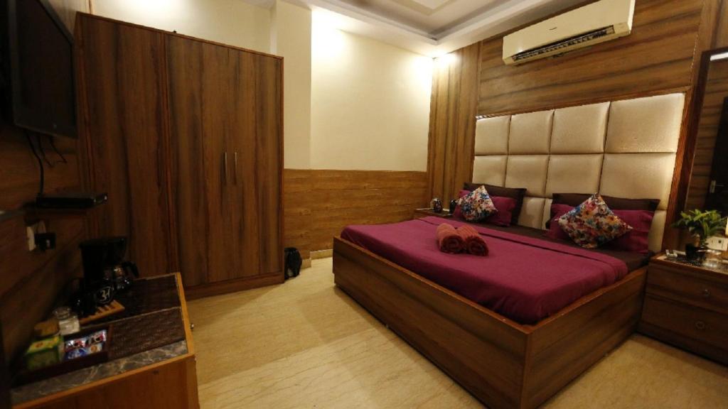 a bedroom with a large bed in a room at Hotel Royal Plaza B&B in New Delhi