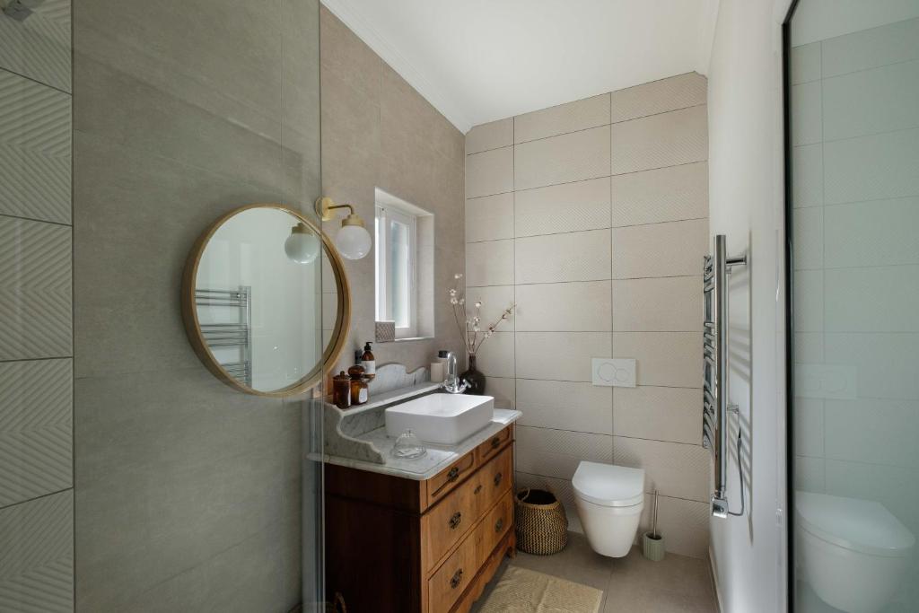 a bathroom with a sink and a mirror at Casa Idalia Boutique Hotel in Comporta