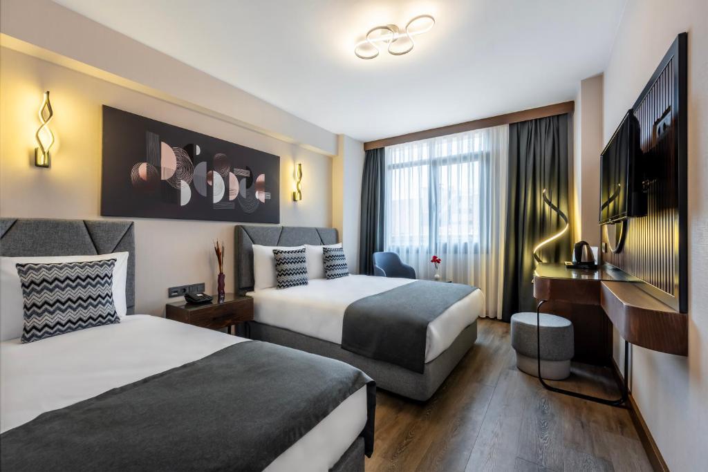 Postel nebo postele na pokoji v ubytování Hotel Bristol