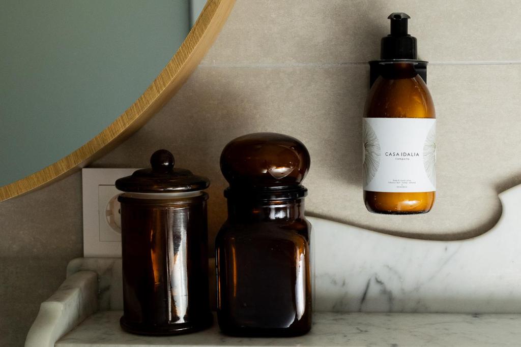 two bottles sitting on a shelf next to a bottle of alcohol at Casa Idalia Boutique Hotel in Comporta