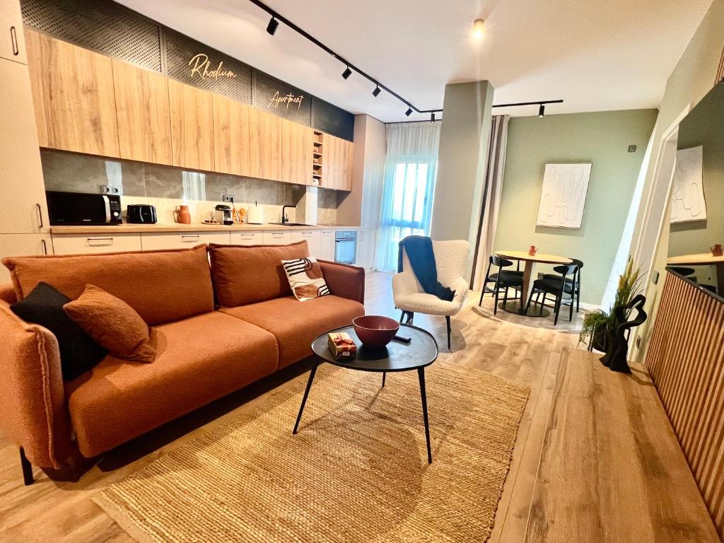 a living room with a couch and a table at Rhodium Apartment in Cluj-Napoca