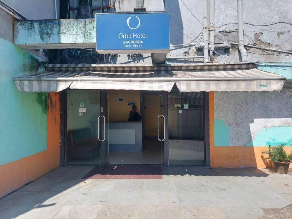 an entrance to a building with a sign on it at Orbit Hotel - Bagdogra in Bāghdogra