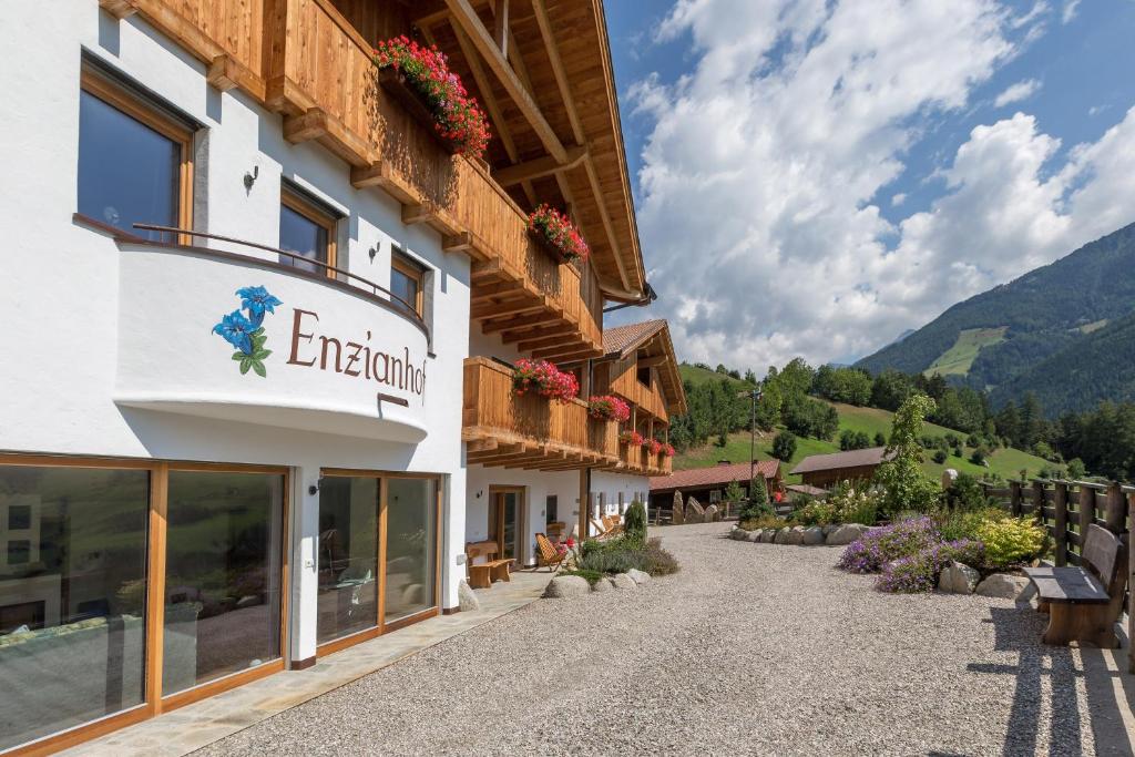a building with a sign on the side of it at Enzianhof - Nature Apartments in San Giovanni in Val Aurina