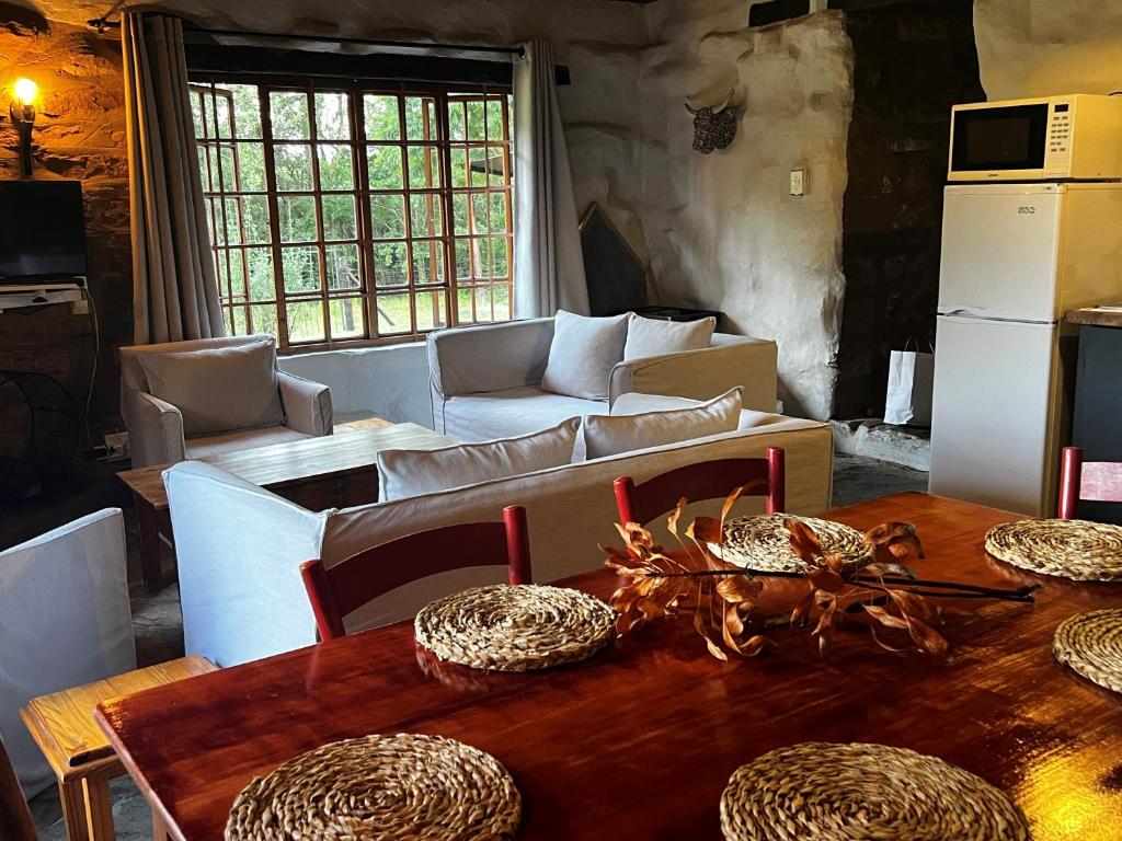 a living room with a table and a couch at Wyford Farm in Van Reenen
