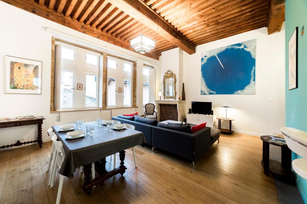 una sala de estar con un sofá y una mesa en Grand duplex au cœur du Vieux Lyon, en Lyon