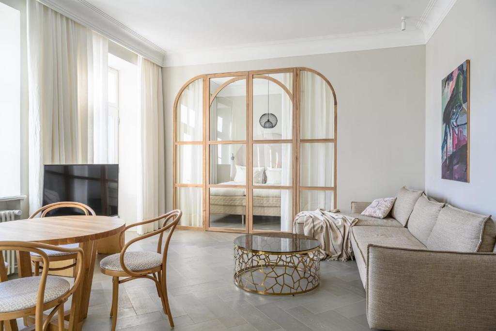 a living room with a couch and a table at Güldenstubbe Residences in Kuressaare