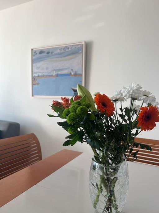 a vase filled with flowers sitting on a table at Superbe Appartement Vue Mer T3 70m2 in Mauguio