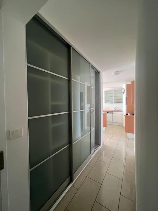 a hallway with green glass cabinets in a room at Superbe Appartement Vue Mer T3 70m2 in Mauguio