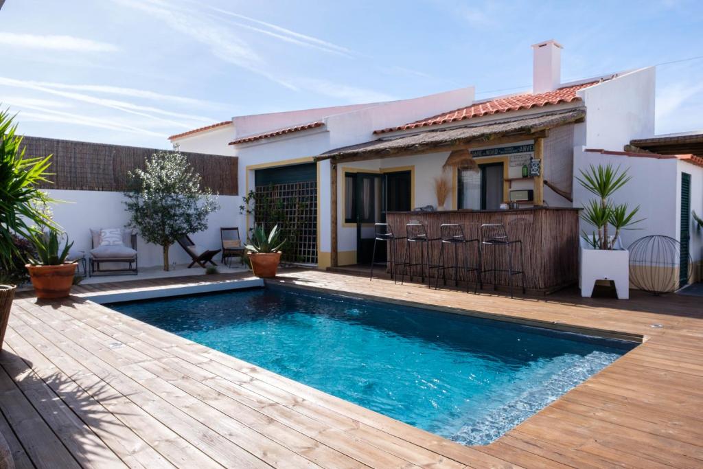 a swimming pool in front of a house at Casa Idalia Boutique Hotel in Comporta