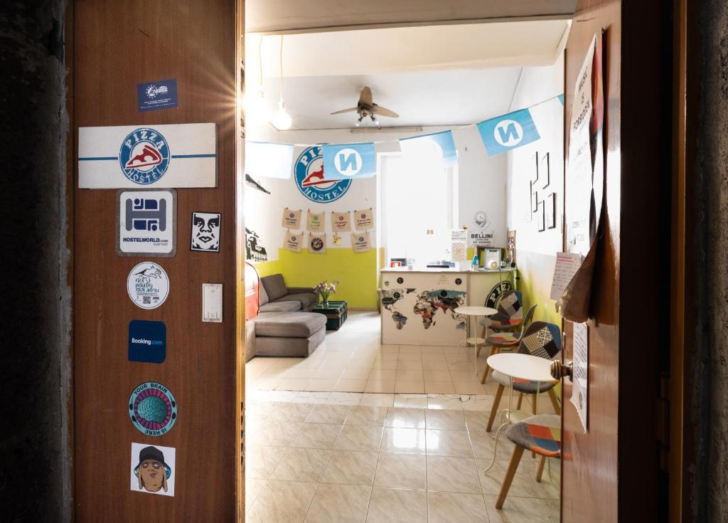 a room with a hallway with signs on the wall at Naples Pizza Hostel in Naples