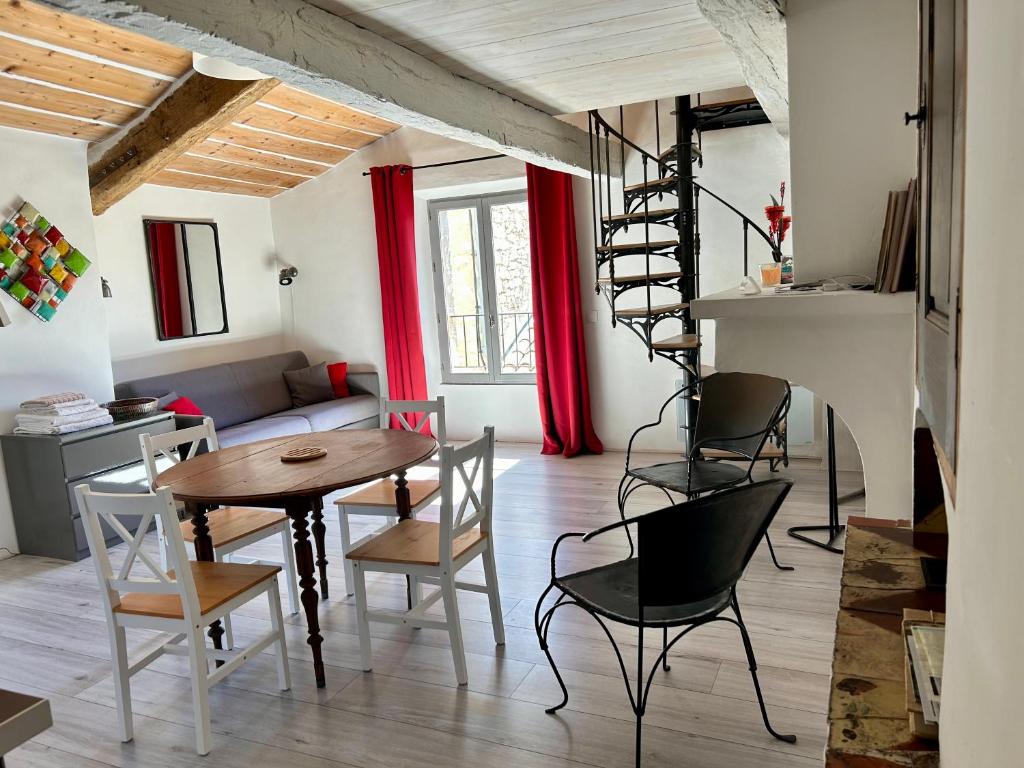 a living room with a wooden table and chairs at LA CALADE in Trigance