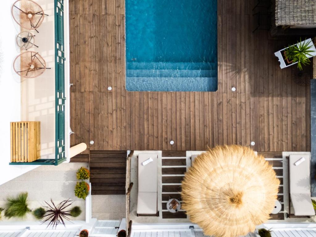 um modelo de resort com piscina e guarda-sol em Casa Idalia Boutique Hotel na Comporta