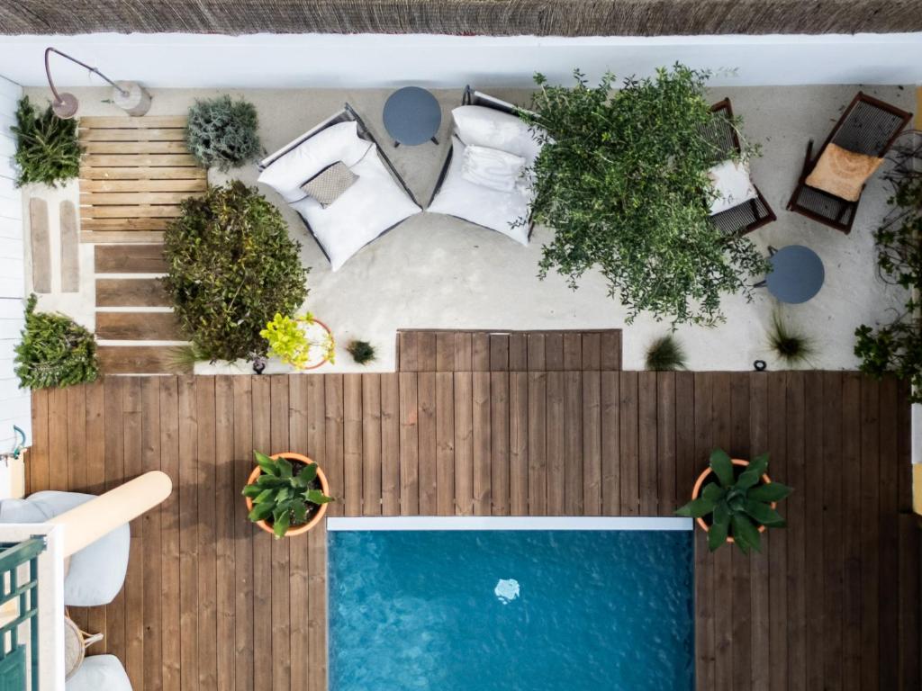 a bedroom with a bed and a swimming pool at Casa Idalia Boutique Hotel in Comporta