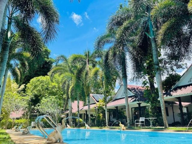 a swimming pool with animals in the middle of a resort at ไอยรารีสอร์ต in Ban Map Khangkhao