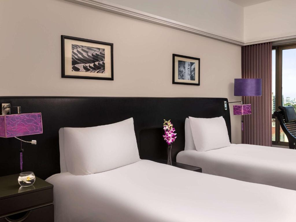 Postel nebo postele na pokoji v ubytování Sofitel Saigon Plaza