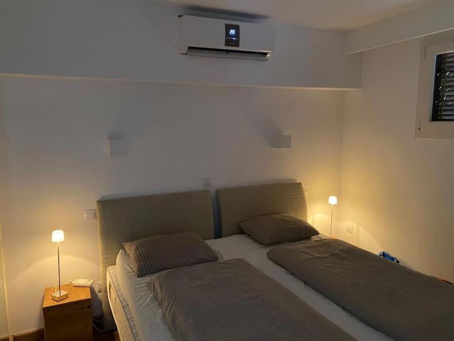 a bedroom with two beds and two lights on the wall at State of the Art Apartment in Magaluf