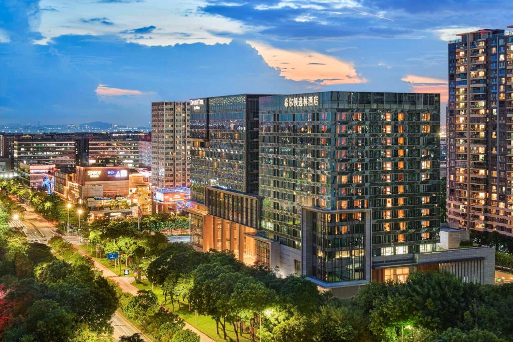 a city skyline at night with tall buildings at Doubletree By Hilton Shenzhen Airport Residences in Shenzhen